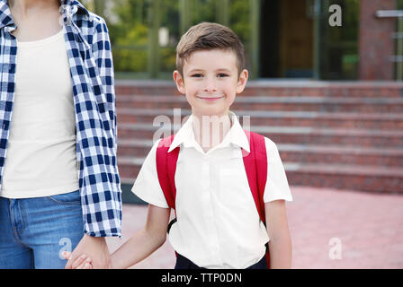 Mother taking son to school Stock Photo