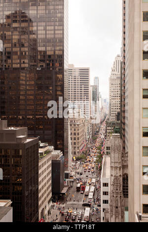High angle view of busy street amidst buildings in city