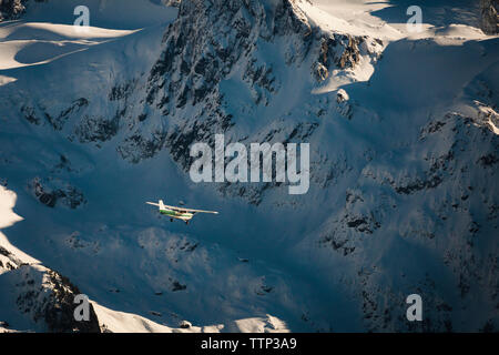 Aerial view of aircraft flying by snowcapped mountain at Garibaldi Park Stock Photo