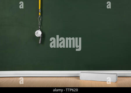 Whistle on blackboard background