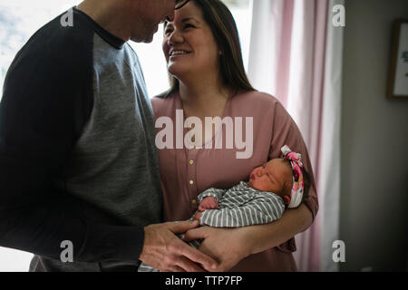 Happy parents with newborn daughter at home Stock Photo