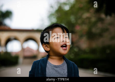 Close-up of cute baby boy screaming while standing in Balboa Park Stock Photo