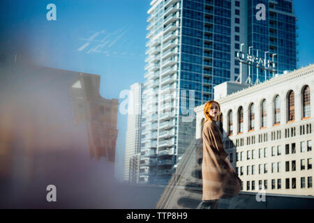Side view portrait of confident woman standing in city Stock Photo