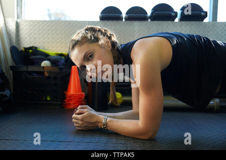 Side view portrait of confident woman exercising at gym Stock Photo
