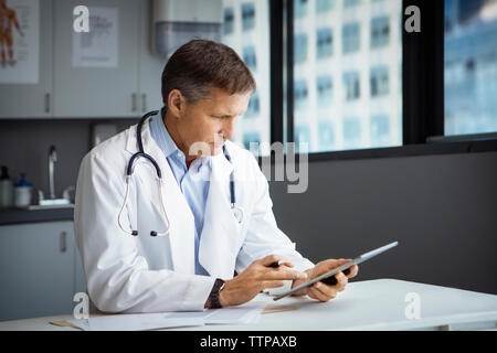 Male doctor using tablet computer in clinic Stock Photo
