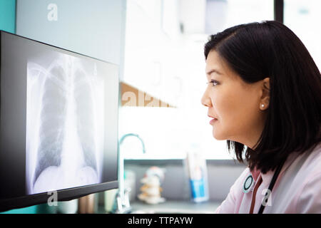 Female doctor examining x-ray on computer in clinic Stock Photo