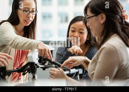 Teacher explaining drone to students in classroom Stock Photo
