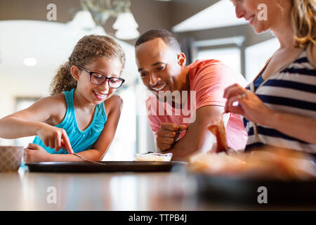 Happy family preparing pizza at home Stock Photo