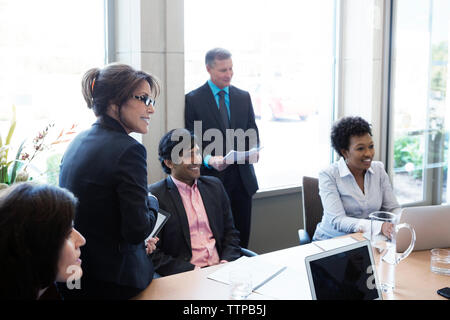 Happy business people discussing in office Stock Photo
