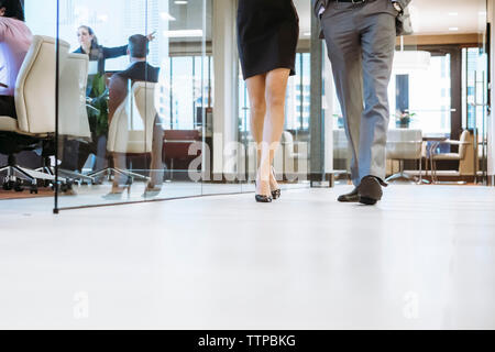 Low section of business people walking in office corridor Stock Photo