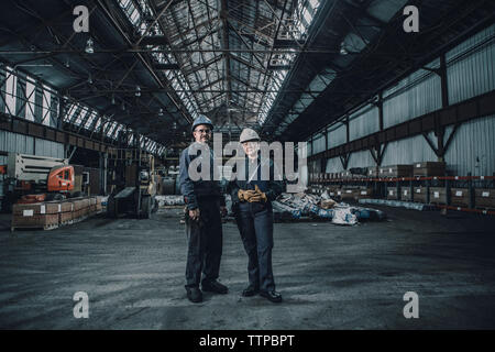 Portrait of confident coworkers standing in metal industry Stock Photo