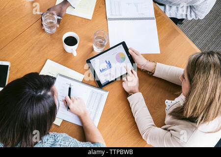 High angle view of businesswoman analyzing data with colleagues in meeting Stock Photo