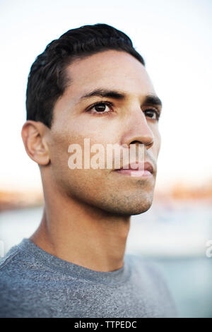 Close-up of thoughtful male athlete against clear sky Stock Photo