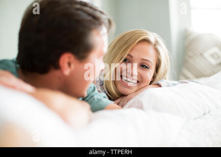 Happy couple relaxing on bed at home Stock Photo