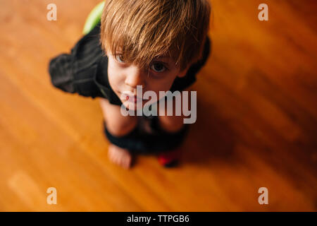 High angle view of boy sitting on baby toilet seat Stock Photo