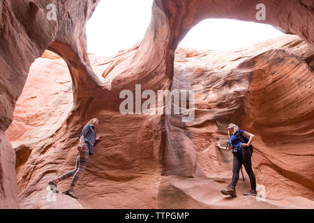 Low angle view of female hikers exploring at canyon Stock Photo