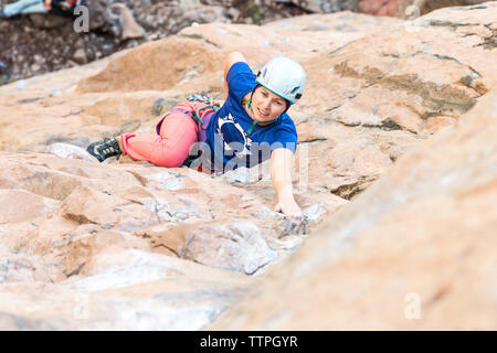 Portrait of woman hiker climbing rock and looking away. Young female hiking  mountain. - 500px
