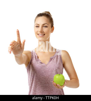 Beautiful girl with apple pointing finger, isolated on white Stock Photo