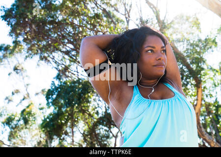 Low angle view of confident woman stretching arms Stock Photo