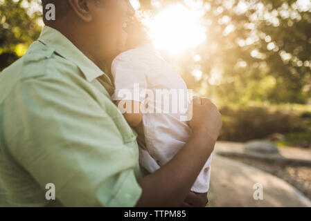 Close-up of happy father embracing son at park Stock Photo