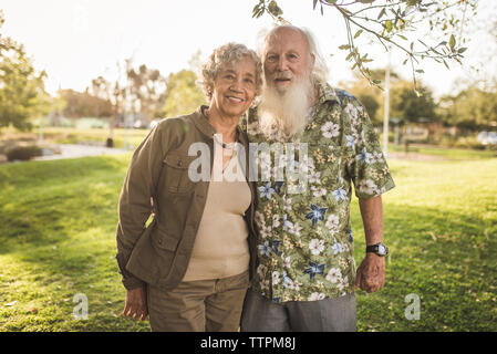 Portrait of confident senior couple standing at park Stock Photo