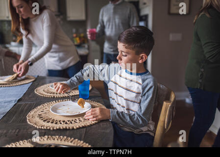 Elementary age boy eating pancakes for breakfast Stock Photo