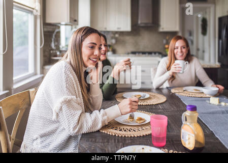 Multigenerational family eating pancakes for breakfast