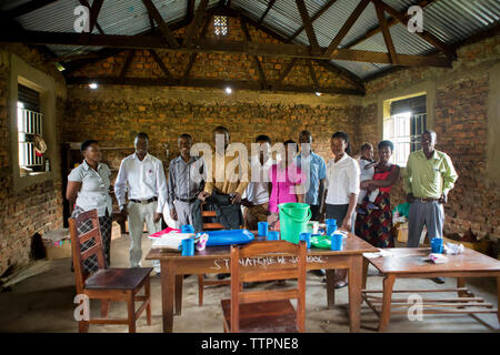 Teachers standing by table in staffroom Stock Photo