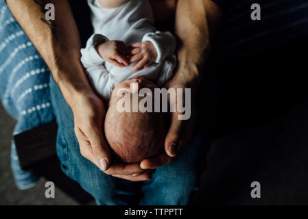 High angle view of father carrying sleeping daughter at home Stock Photo