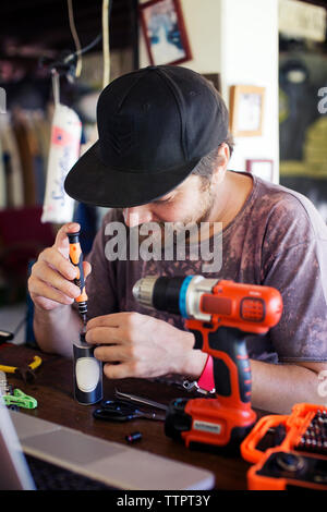 Man using screwdriver in workshop Stock Photo
