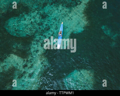 Young woman on stand up paddling board Stock Photo