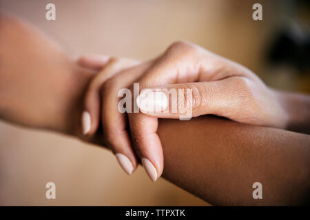 Cropped image of woman touching hand Stock Photo