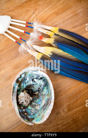 Blue feathers and burnt sage await the cacao ceremony before wedding Stock Photo