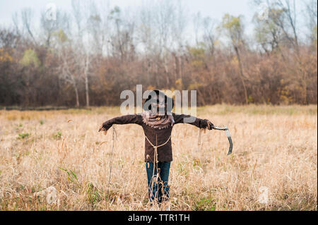 Boy poses in scarecrow halloween costume in field Stock Photo
