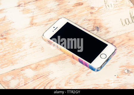 Smartphone isolated on wooden background Stock Photo