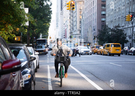 Happy man riding bicycle on city street Stock Photo