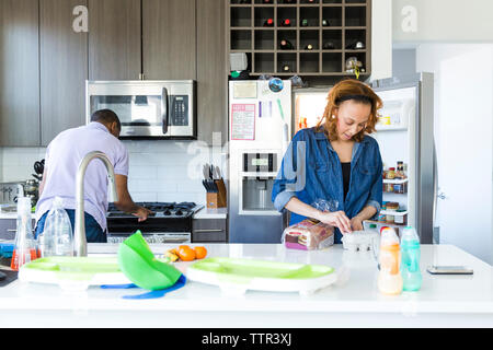 Couple working together in kitchen Stock Photo
