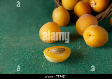 Heap of fresh apricots on green table Stock Photo