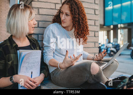 Two young students at the University using laptop Stock Photo