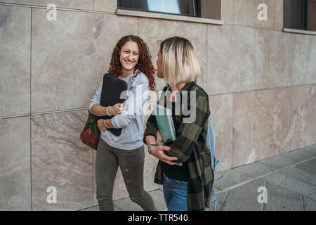 Two young students walking together in the college Stock Photo