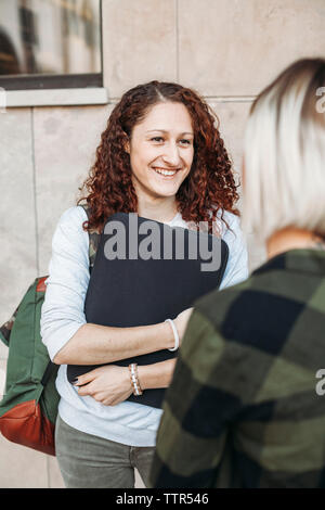 Two young students talking together in the college Stock Photo