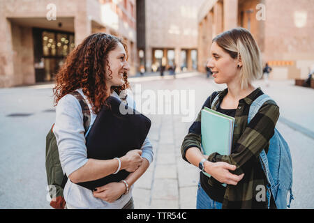 Two young students talking together in the college Stock Photo