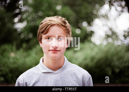 Portrait of smiling teenage boy outdoors Stock Photo
