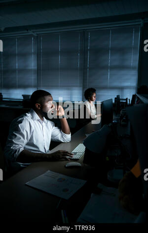 Coworkers working on desktop computers in office Stock Photo