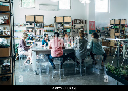 business people having discussion during meeting while sitting at conference table Stock Photo
