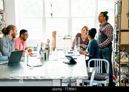 Happy business people having discussion in meeting Stock Photo