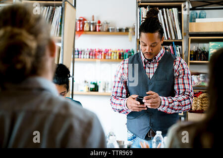businessman using smart phone during meeting in office Stock Photo