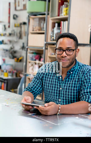 Portrait of confident businessman using tablet computer Stock Photo