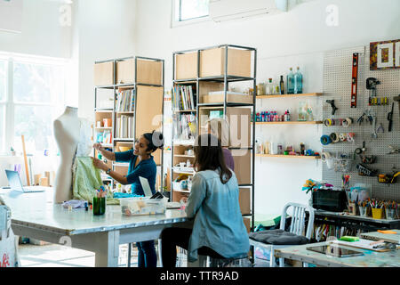 Design professionals working on mannequin in creative office Stock Photo