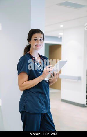 Portrait of confident female doctor using tablet computer in hospital Stock Photo